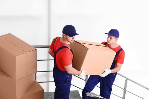 Moving crew navigating stairs during a flat move in Gospeloak